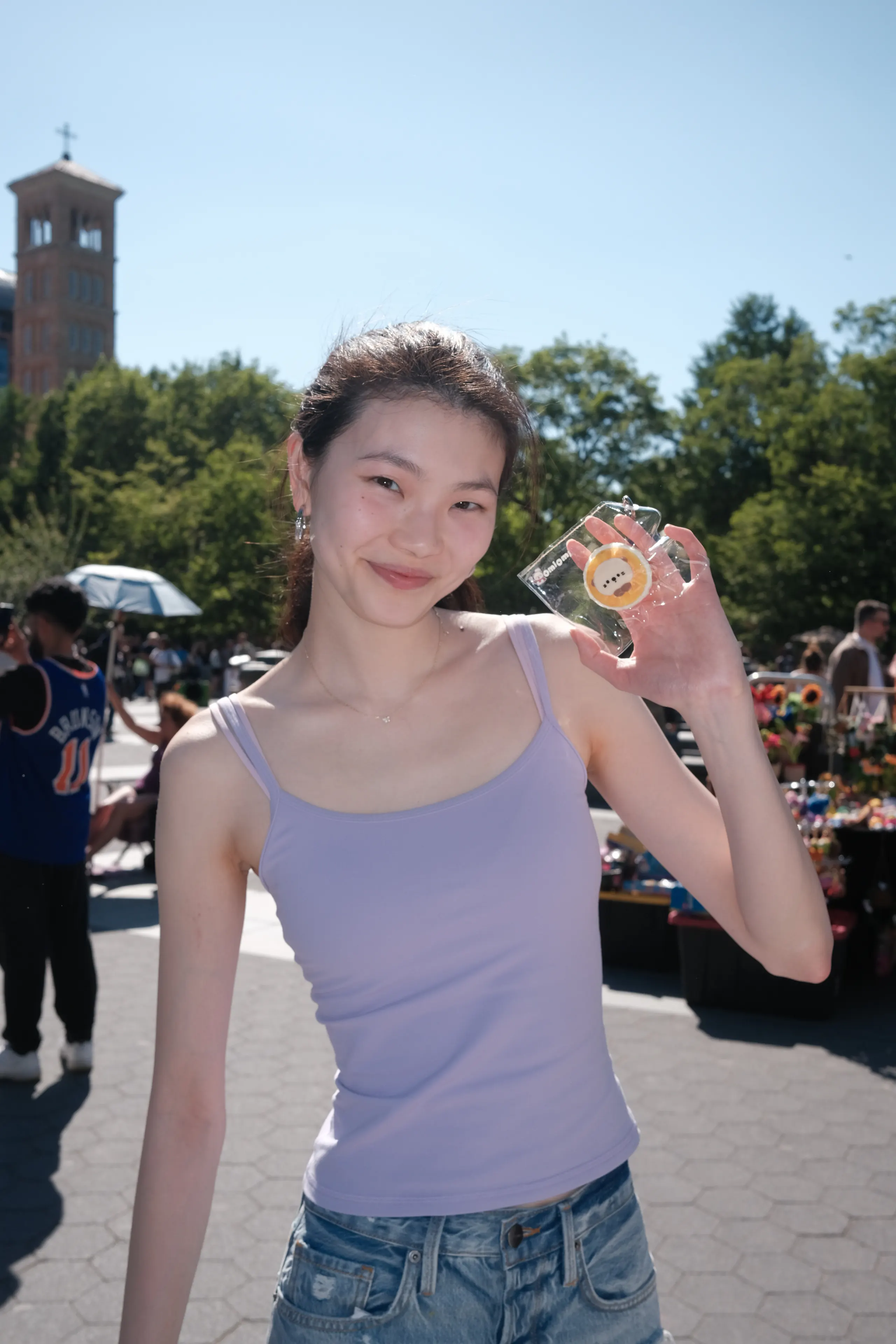 A visitor with an OMIOMI object at an outdoor event