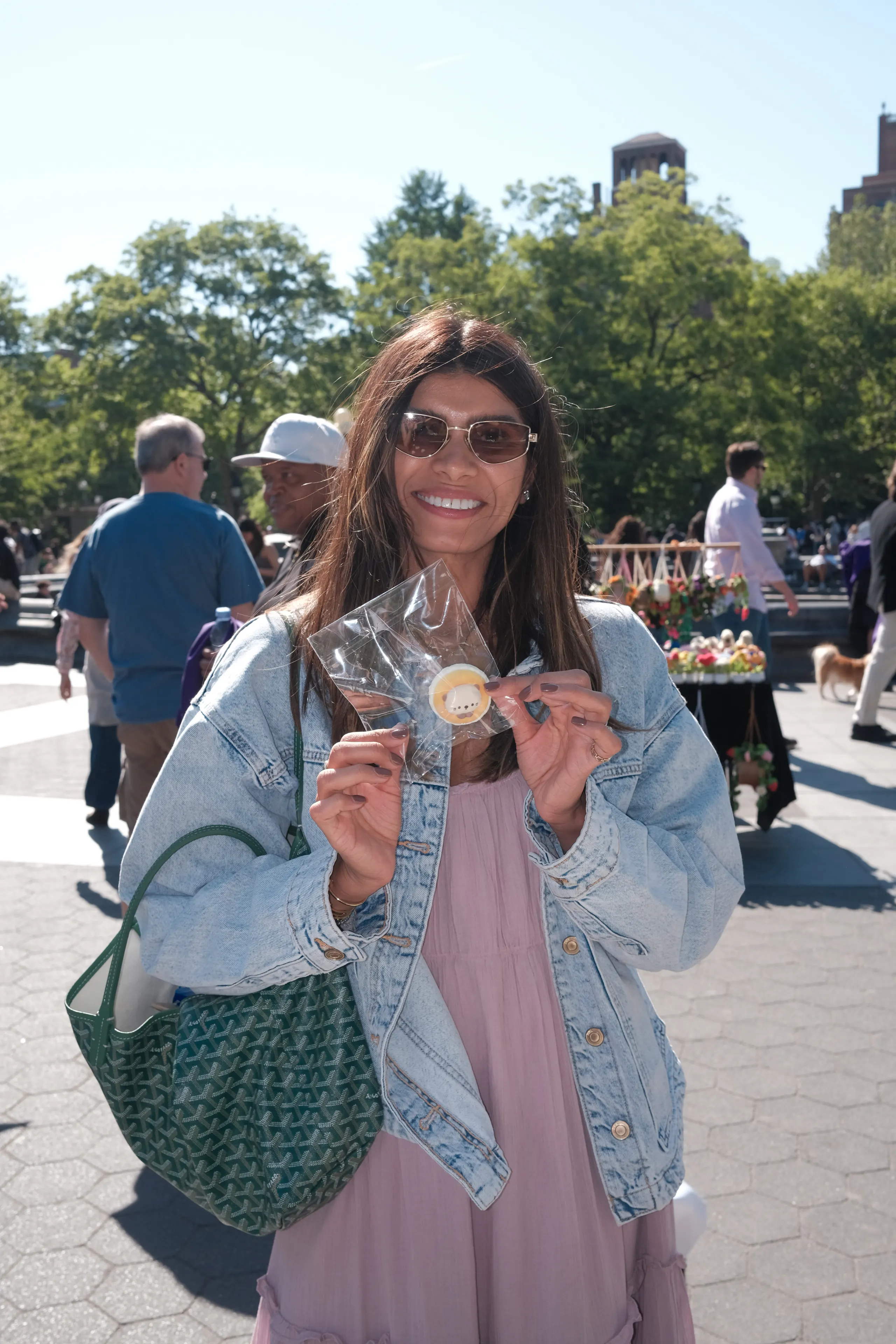 A visitor holding an OMIOMI object outdoors
