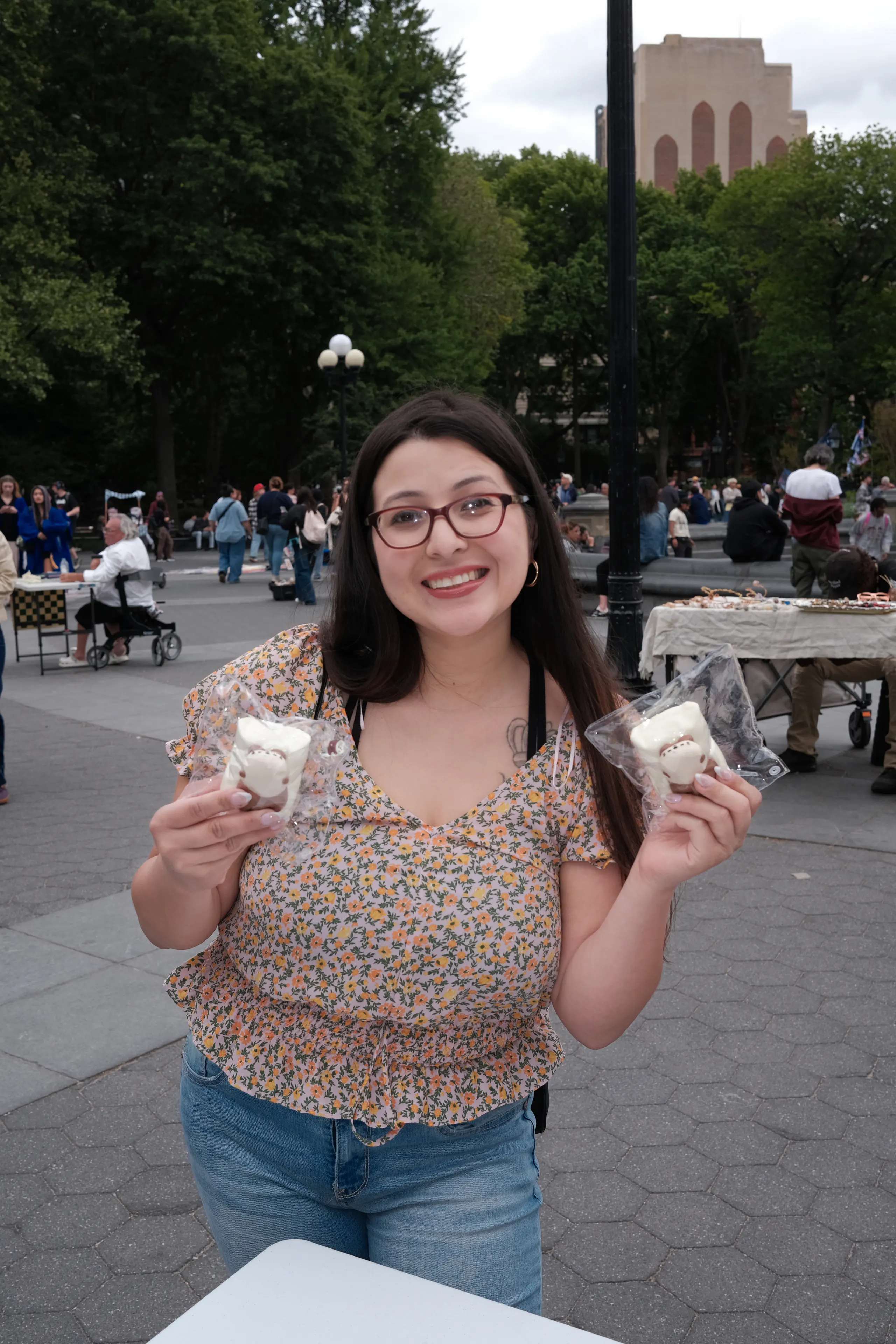 A visitor holding OMIOMI pieces outdoors